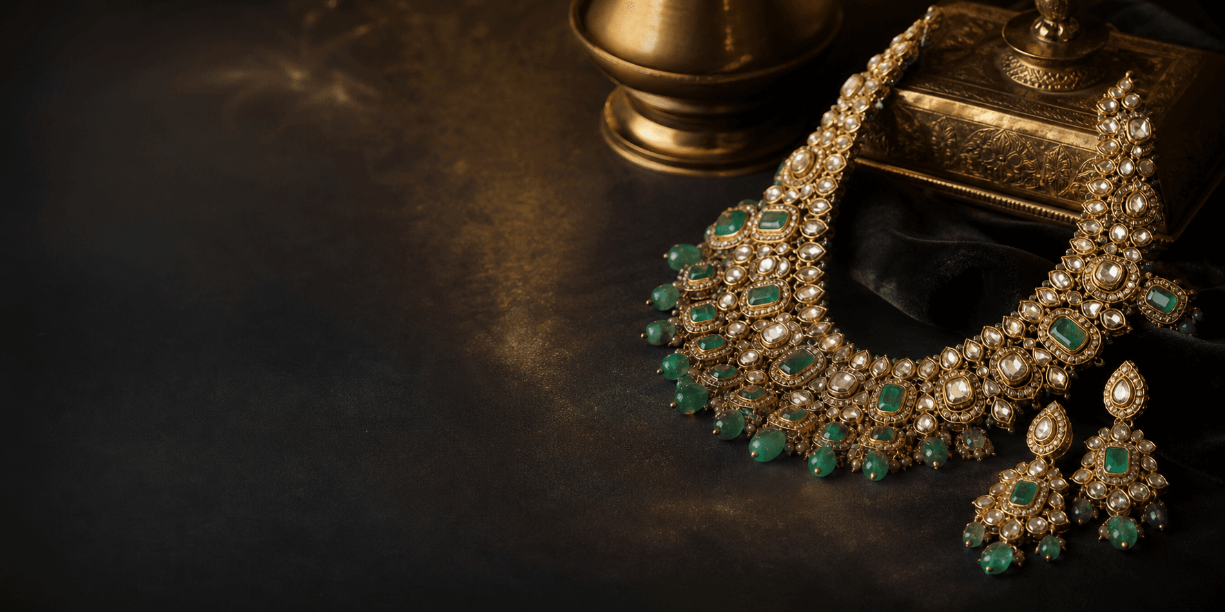 Emerald and uncut diamond necklace on dark velvet for the Beyond Extraordinary hero.